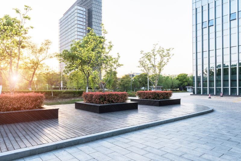 A beautifully done walkway with shrubs planted in big concrete vases