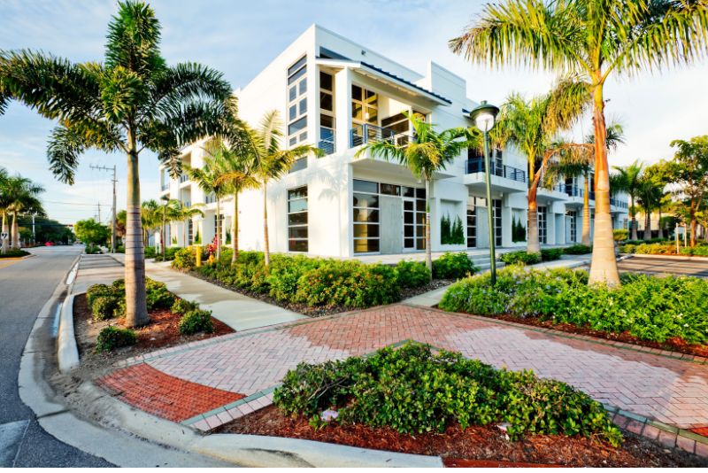 A landscaped two stroery building with pavements and grass planted on the compound